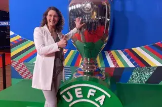 Kathrin Lehmann Kathrin Lehmann touches a big version of the UEFA EURO 2024 trophy and smiles